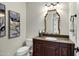 Stylish powder room with a dark wood vanity and granite countertop at 15522 E Cactus Dr, Fountain Hills, AZ 85268