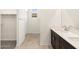 Elegant bathroom features a double vanity and a walk-in closet at 16029 W Desert Hollow Dr, Surprise, AZ 85387