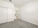 Neutral bedroom features plush carpeting and a closet with sliding doors at 16029 W Desert Hollow Dr, Surprise, AZ 85387