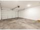 Spacious garage with an automatic door opener and a concrete floor at 16029 W Desert Hollow Dr, Surprise, AZ 85387