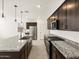 Open kitchen featuring granite countertops, stainless steel appliances, dark cabinets and island sink at 16029 W Desert Hollow Dr, Surprise, AZ 85387