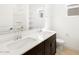 Bright bathroom featuring double sinks, vanity, and ample counter space, complemented by a large mirror and fixtures at 16074 W Prickly Pear Trl, Surprise, AZ 85387