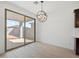 Dining area with sliding glass doors leading to the patio, wood-look tile, modern lighting at 16074 W Prickly Pear Trl, Surprise, AZ 85387