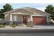 One-story home with brown garage door and stone accents at 16074 W Prickly Pear Trl, Surprise, AZ 85387