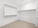 A spacious walk-in closet offers ample storage with built in shelving and closet rods in a well-lit space at 16074 W Prickly Pear Trl, Surprise, AZ 85387