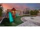 Backyard with playset, trampoline, and fire pit at 17152 W Grant St, Goodyear, AZ 85338