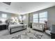 Main bedroom with tufted headboard, plenty of natural light, and a crib at 17152 W Grant St, Goodyear, AZ 85338