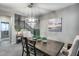 Bright dining room featuring a wooden table and chandelier at 17152 W Grant St, Goodyear, AZ 85338