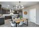 Eat-in kitchen with dark wood cabinets, granite island, and modern lighting at 17152 W Grant St, Goodyear, AZ 85338