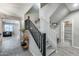 Staircase with black railing and gray carpet at 17152 W Grant St, Goodyear, AZ 85338