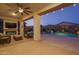 Relaxing patio with fireplace, pool, and string lights at 19930 W Exeter Blvd, Litchfield Park, AZ 85340