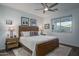 Main bedroom with wood bed frame and access to en-suite bathroom at 19930 W Exeter Blvd, Litchfield Park, AZ 85340