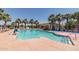 Inviting community pool with lounge chairs and palm trees at 19930 W Exeter Blvd, Litchfield Park, AZ 85340