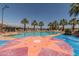 Inviting community pool with starburst design and palm trees at 19930 W Exeter Blvd, Litchfield Park, AZ 85340