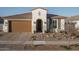 House exterior featuring a brown garage door and desert landscaping at 19930 W Exeter Blvd, Litchfield Park, AZ 85340