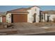 House exterior featuring a brown garage door and desert landscaping at 19930 W Exeter Blvd, Litchfield Park, AZ 85340