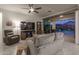 Living room with sliding doors and view of the pool at night at 19930 W Exeter Blvd, Litchfield Park, AZ 85340