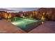 Relaxing rectangular pool with water feature at night at 19930 W Exeter Blvd, Litchfield Park, AZ 85340