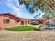 Landscaped backyard with artificial turf and stonework at 215 E Marconi Ave, Phoenix, AZ 85022