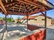 Relaxing backyard gazebo with red wood accents and a view of the home at 215 E Marconi Ave, Phoenix, AZ 85022