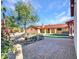 Spacious backyard patio with a tree and access to the house at 215 E Marconi Ave, Phoenix, AZ 85022