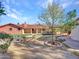 View of the backyard with lawn and stone accents at 215 E Marconi Ave, Phoenix, AZ 85022