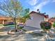 Landscaped backyard with a tree and brick pathway at 215 E Marconi Ave, Phoenix, AZ 85022