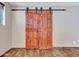 Rustic barn door adds character to this room at 215 E Marconi Ave, Phoenix, AZ 85022