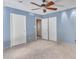 Spacious bedroom with tile flooring and sliding closet doors at 215 E Marconi Ave, Phoenix, AZ 85022