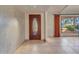 Elegant entryway with a wood door and tile floor at 215 E Marconi Ave, Phoenix, AZ 85022