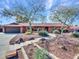 Ranch-style home with mature trees, walkway, and attached garage at 215 E Marconi Ave, Phoenix, AZ 85022