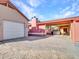 View of detached garage and paved driveway with house and covered patio visible at 215 E Marconi Ave, Phoenix, AZ 85022