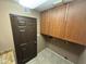 Laundry room with wood cabinets and additional storage at 215 E Marconi Ave, Phoenix, AZ 85022