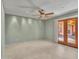 Living room with tile floors, French doors, and ceiling fan at 215 E Marconi Ave, Phoenix, AZ 85022