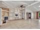 Open living room with tile floors, fireplace, and built-in shelving at 215 E Marconi Ave, Phoenix, AZ 85022