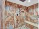 Spacious walk-in shower with pebble floor and built-in seat at 215 E Marconi Ave, Phoenix, AZ 85022