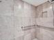 Walk-in shower with grab bars and neutral tile at 215 E Marconi Ave, Phoenix, AZ 85022