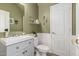 Clean bathroom with gray vanity, toilet and white sink at 30084 N Desert Willow Blvd, San Tan Valley, AZ 85143