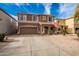 Two-story house with a brown exterior, two-car garage, and landscaped front yard at 30084 N Desert Willow Blvd, San Tan Valley, AZ 85143