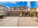 Two-story house with a brown exterior, two-car garage, and landscaped front yard at 30084 N Desert Willow Blvd, San Tan Valley, AZ 85143