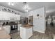 Kitchen features an island, white cabinets, and stainless steel appliances at 30084 N Desert Willow Blvd, San Tan Valley, AZ 85143