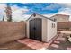 Large storage shed in the backyard with brick pavers at 30084 N Desert Willow Blvd, San Tan Valley, AZ 85143