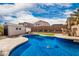 Inviting kidney-shaped pool with large backyard and shed at 30084 N Desert Willow Blvd, San Tan Valley, AZ 85143