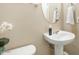 Small bathroom with pedestal sink, oval mirror, and decorative accents at 3039 W Sand Flower Dr, Phoenix, AZ 85086