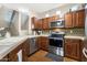 Modern kitchen with stainless steel appliances and wood cabinets at 3039 W Sand Flower Dr, Phoenix, AZ 85086