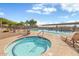 Community pool and spa with surrounding lounge chairs at 3039 W Sand Flower Dr, Phoenix, AZ 85086