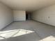 Unfinished garage interior with concrete floor and drywall at 32111 N Saddlehorn Dr, San Tan Valley, AZ 85140