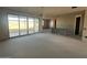 Unfinished great room with sliding glass doors and island at 32111 N Saddlehorn Dr, San Tan Valley, AZ 85140