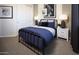 Well-lit bedroom with a navy blue bedspread and metal frame at 32359 N 19Th Ln, Phoenix, AZ 85085