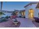 Brick-paved courtyard with seating area and lush landscaping near the home entrance at 3604 N 162Nd Ave, Goodyear, AZ 85395